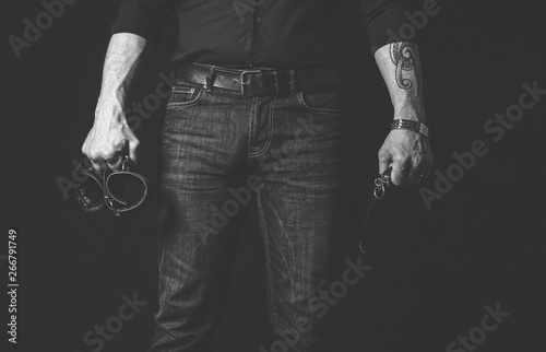 Фотография Strict man with black collar and black cuffs. BDSM concept.