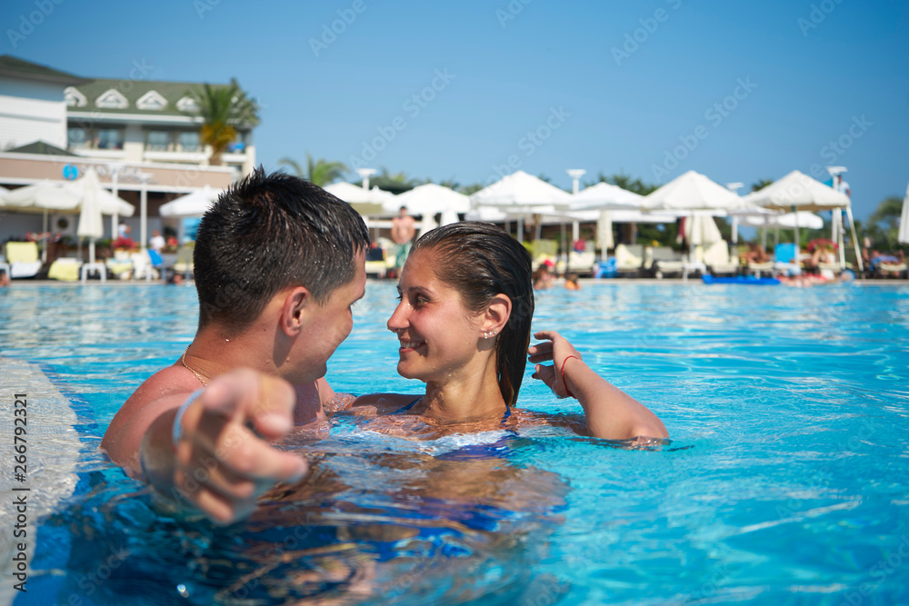 Couple in the pool, discuss something