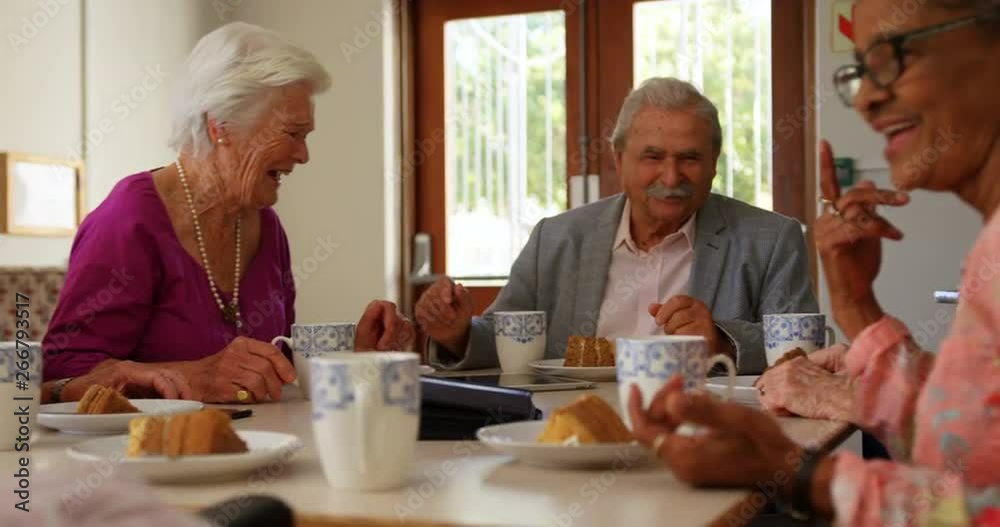 Group of Mixed-race senior friends eating breakfast on dining table Group of Mixed-race senior friends eating breakfast on dining table