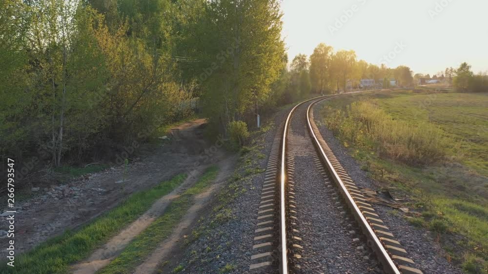 Movement on a single-track railway in the rays of the setting sun Movement on a single-track railway in the rays of the setting sun