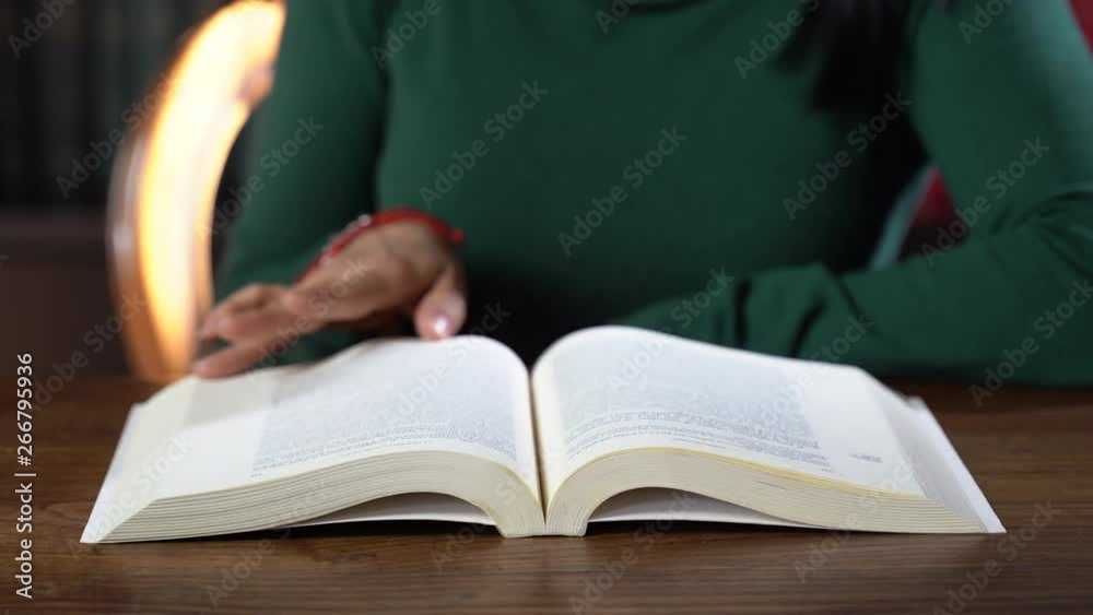 Woman reading old book in library. Education concept Woman reading old book in library. Education concept