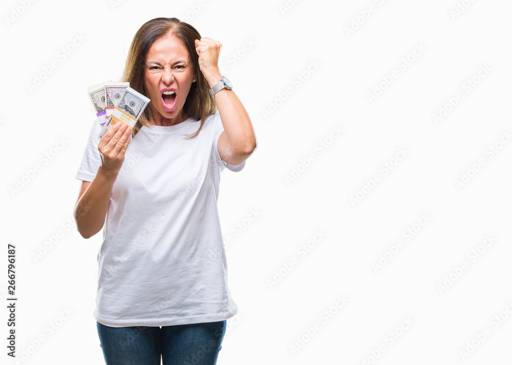 Middle age hispanic woman holding bunch of dollars over isolated background annoyed and frustrated shouting with anger, crazy and yelling with raised hand, anger concept Middle age hispanic woman holding bunch of dollars over isolated background annoyed and frustrated shouting with anger, crazy and yelling with raised hand, anger concept