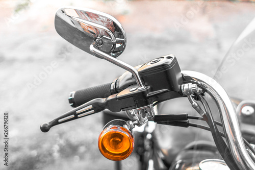 Classic chrome cruiser. Motorcycle handle. Front brake. The gas lever on the chopper. Speed dialing. Details of the motorcycle close-up. Part of the biker steering. Front turn signal. © Larysa