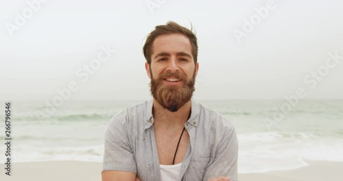 Front view of Caucasian man relaxing on the beach 4k photo