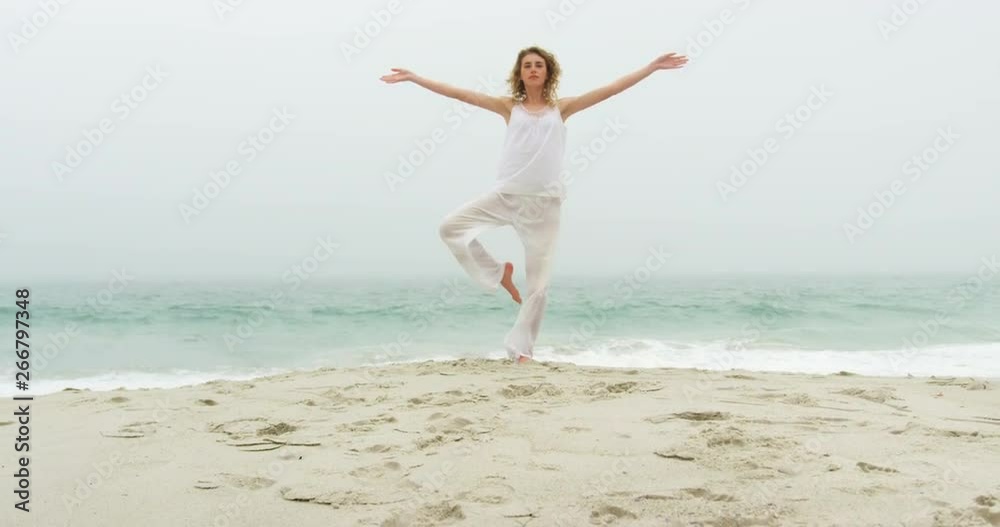Front view of Caucasian woman performing yoga on the beach 4k Front view of Caucasian woman performing yoga on the beach 4k