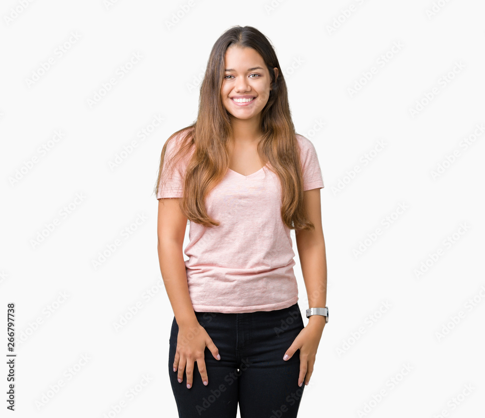 Young beautiful brunette woman wearing pink t-shirt over isolated background with a happy and cool smile on face. Lucky person. Young beautiful brunette woman wearing pink t-shirt over isolated background with a happy and cool smile on face. Lucky person.
