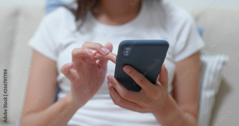 Close up of woman use of smart phone at home Close up of woman use of smart phone at home