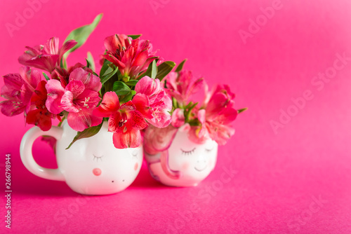 Unicorn mugs with Alstroemeria on bright pink background. Idea of Girly settings. Vivid postcard for any holidays © manuta