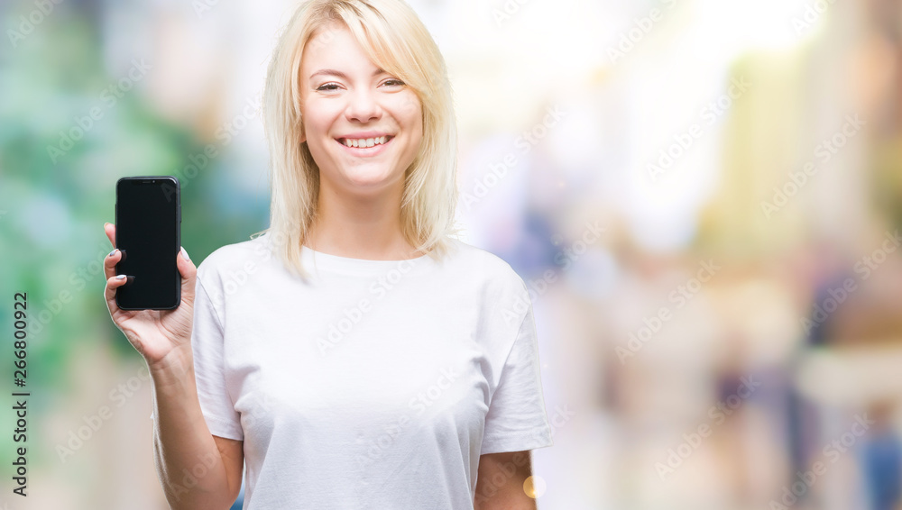 Young beautiful blonde woman showing screen of smartphone over isolated background with a happy face standing and smiling with a confident smile showing teeth