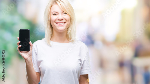 Young beautiful blonde woman showing screen of smartphone over isolated background with a happy face standing and smiling with a confident smile showing teeth
