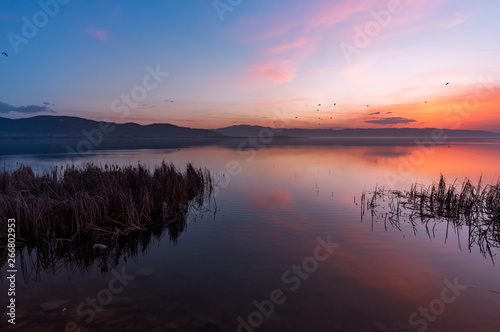Beautiful sunrise on the lake. Colorful sky. © Inga Av