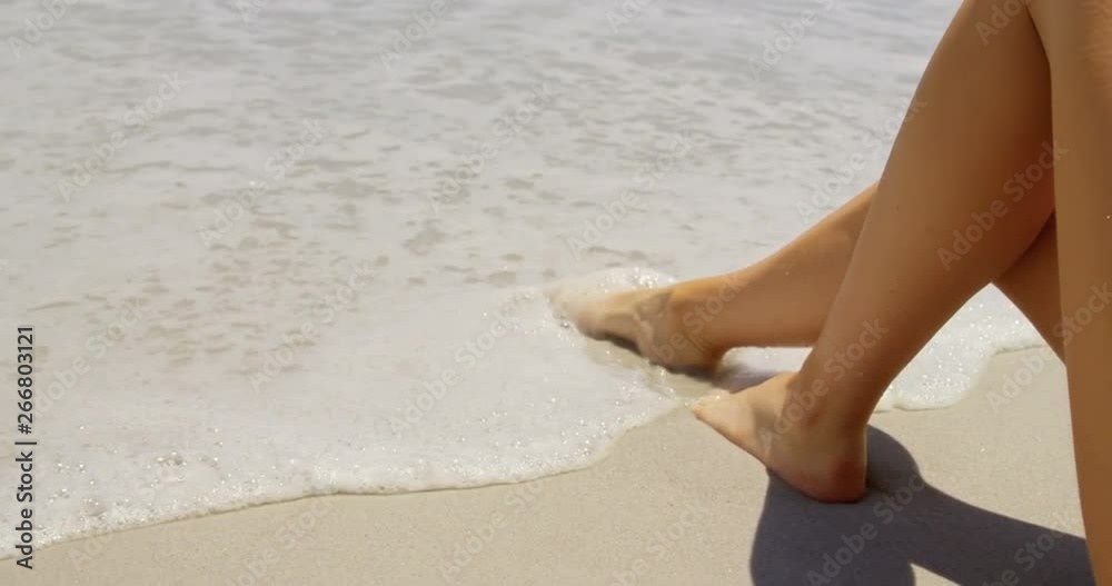 Low section of woman relaxing on the beach 4k Low section of woman relaxing on the beach 4k