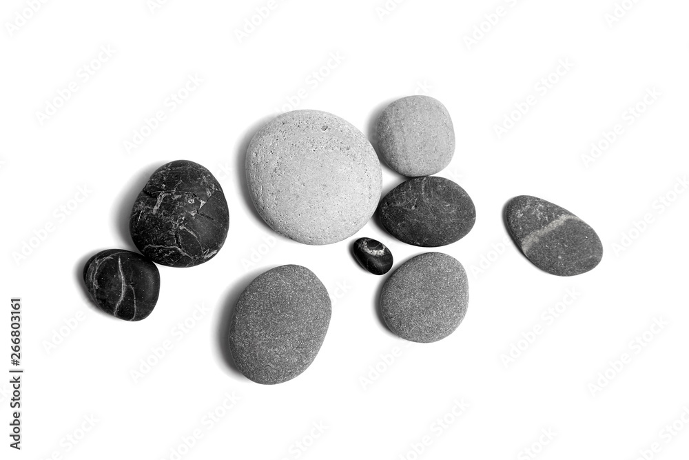 Scattered sea pebbles. Smooth gray and black stones isolated on white background. Top view Scattered sea pebbles. Smooth gray and black stones isolated on white background. Top view