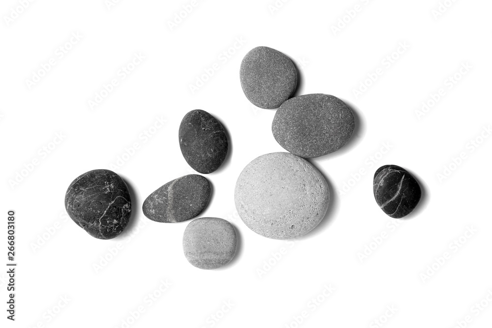 Scattered sea pebbles. Smooth gray and black stones isolated on white background. Top view Scattered sea pebbles. Smooth gray and black stones isolated on white background. Top view