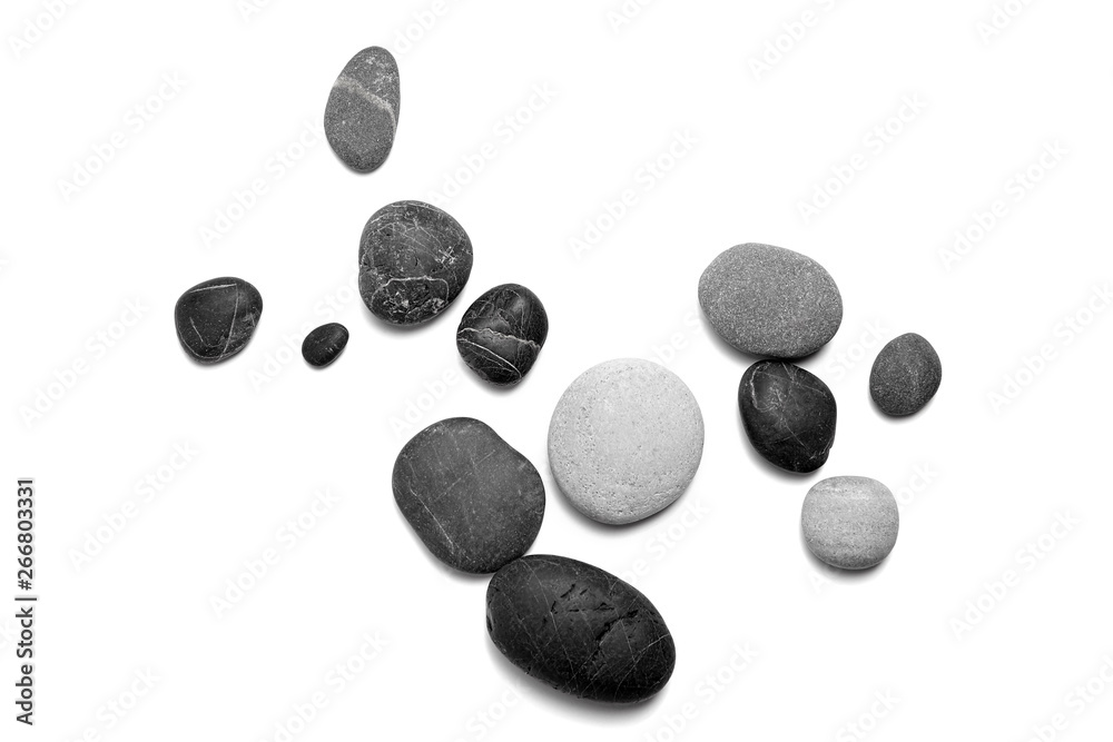 Scattered sea pebbles. Smooth gray and black stones isolated on white background. Top view Scattered sea pebbles. Smooth gray and black stones isolated on white background. Top view