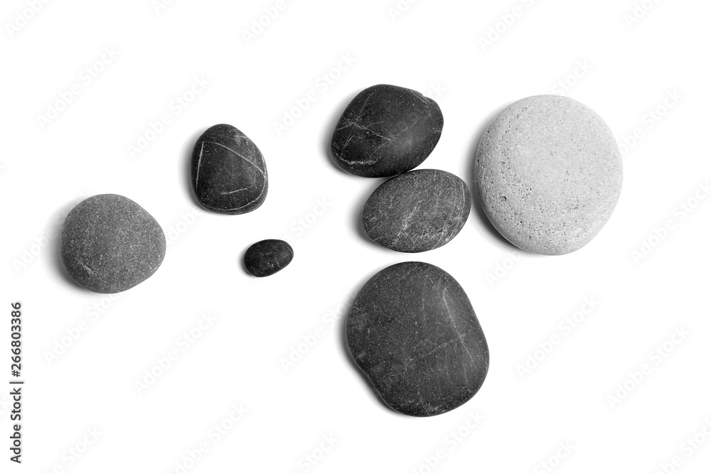 Scattered sea pebbles. Smooth gray and black stones isolated on white background. Top view Scattered sea pebbles. Smooth gray and black stones isolated on white background. Top view