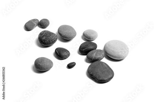 Scattered sea pebbles. Heap of smooth gray and black stones isolated on white background