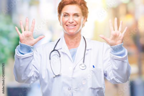 Senior caucasian doctor woman wearing medical uniform over isolated background showing and pointing up with fingers number ten while smiling confident and happy.