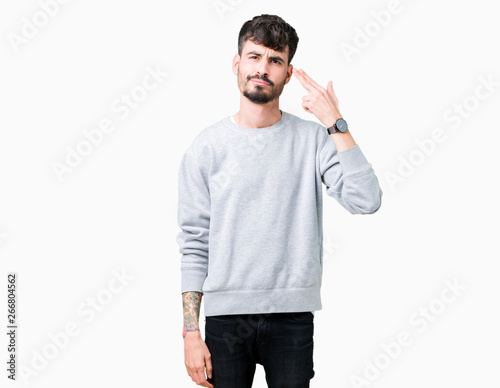 Canvas Print Young handsome man wearing sweatshirt over isolated background Shooting and killing oneself pointing hand and fingers to head, suicide gesture