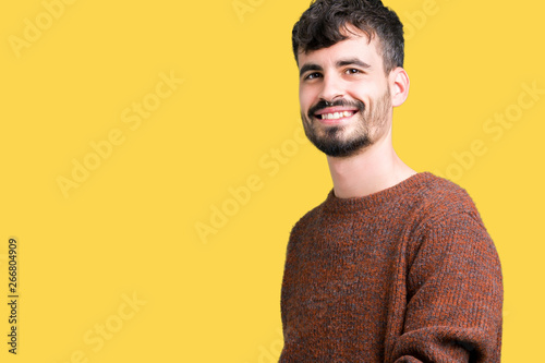 Young handsome man wearing winter sweater over isolated background Inviting to enter smiling natural with open hand