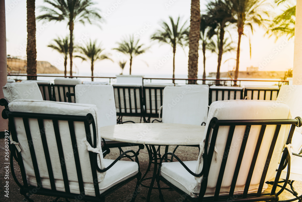 white chairs and table outdoor with sea view