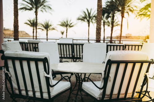 white chairs and table outdoor with sea view
