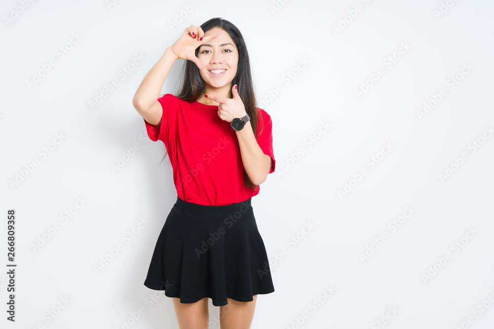 Beautiful brunette woman wearing red t-shirt and skirt over isolated background smiling making frame with hands and fingers with happy face. Creativity and photography concept. Beautiful brunette woman wearing red t-shirt and skirt over isolated background smiling making frame with hands and fingers with happy face. Creativity and photography concept.