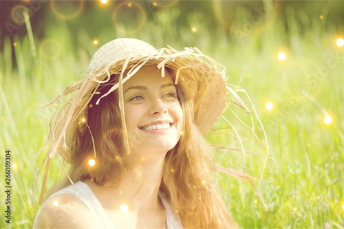 Young woman on field under sunset light