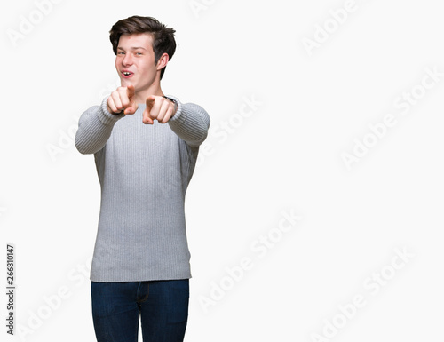 Young handsome man wearing winter sweater over isolated background Pointing to you and the camera with fingers, smiling positive and cheerful