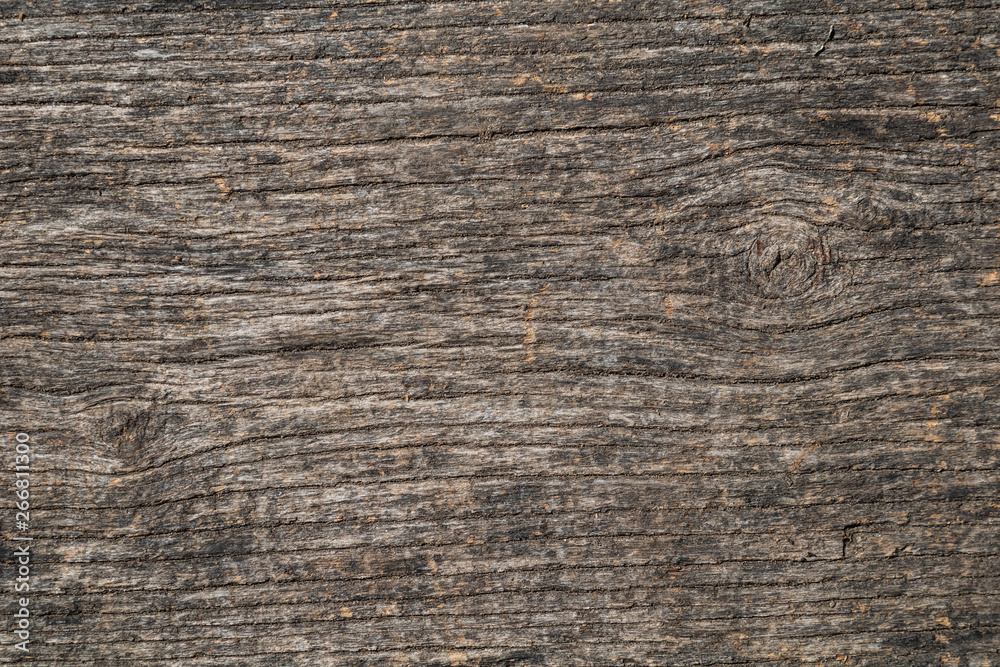 Fototapeta premium Rough brown wood texture background with horizontal grain and dark lines.