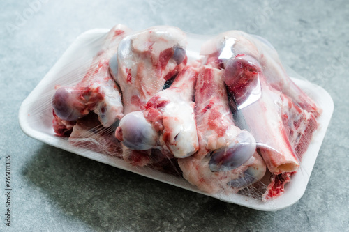 Raw Lamb Bone Marrow in Plastic Container Package with Stretch Film Foil.