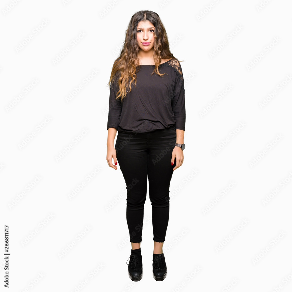 Beautiful young woman with long hair with serious expression on face. Simple and natural looking at the camera. Beautiful young woman with long hair with serious expression on face. Simple and natural looking at the camera.
