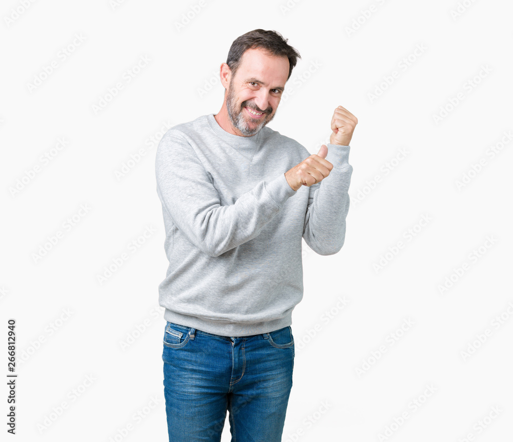 Handsome middle age senior man wearing a sweatshirt over isolated background Pointing to the back behind with hand and thumbs up, smiling confident Handsome middle age senior man wearing a sweatshirt over isolated background Pointing to the back behind with hand and thumbs up, smiling confident