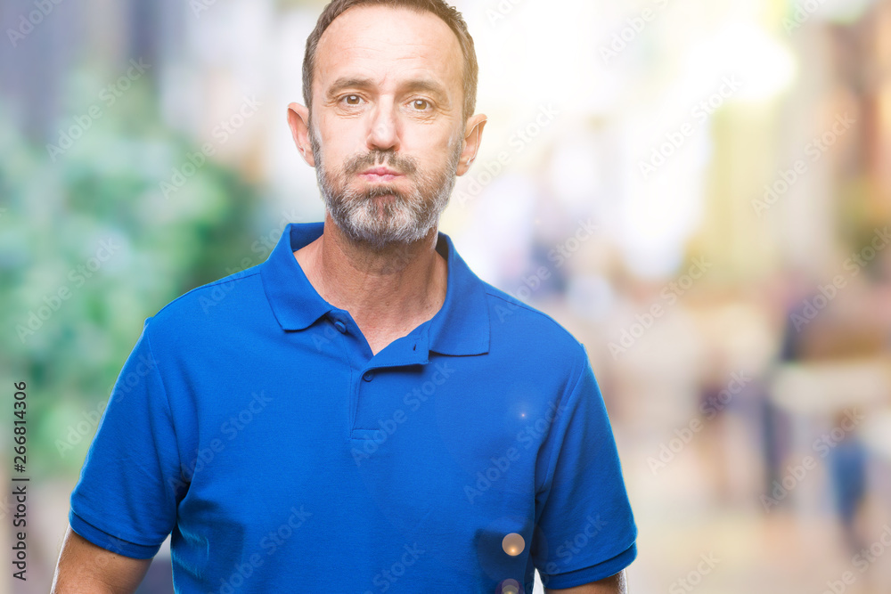 Middle age hoary senior man over isolated background puffing cheeks with funny face. Mouth inflated with air, crazy expression. Middle age hoary senior man over isolated background puffing cheeks with funny face. Mouth inflated with air, crazy expression.