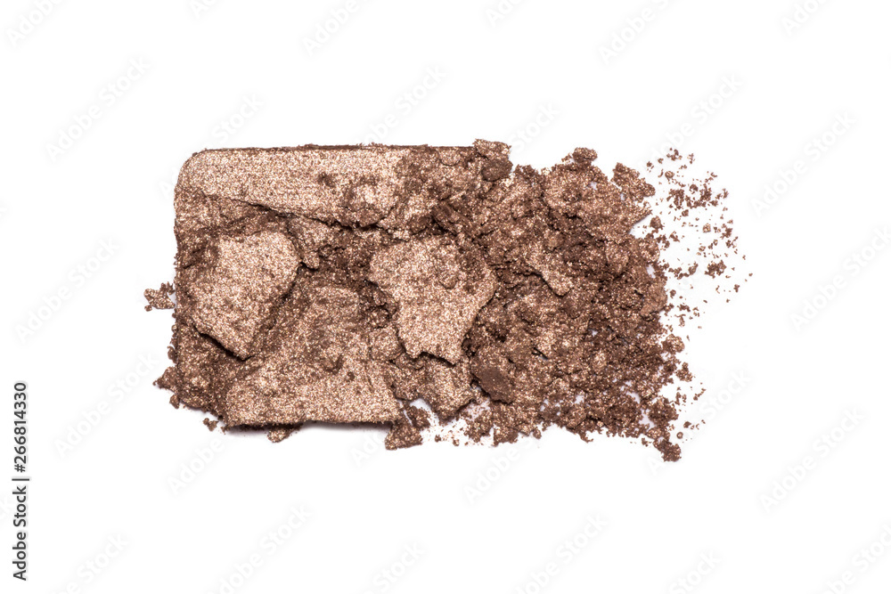 Eyeshadow sample isolated on white background. Crushed brown metallic eye shadows. Closeup of a makeup product.
