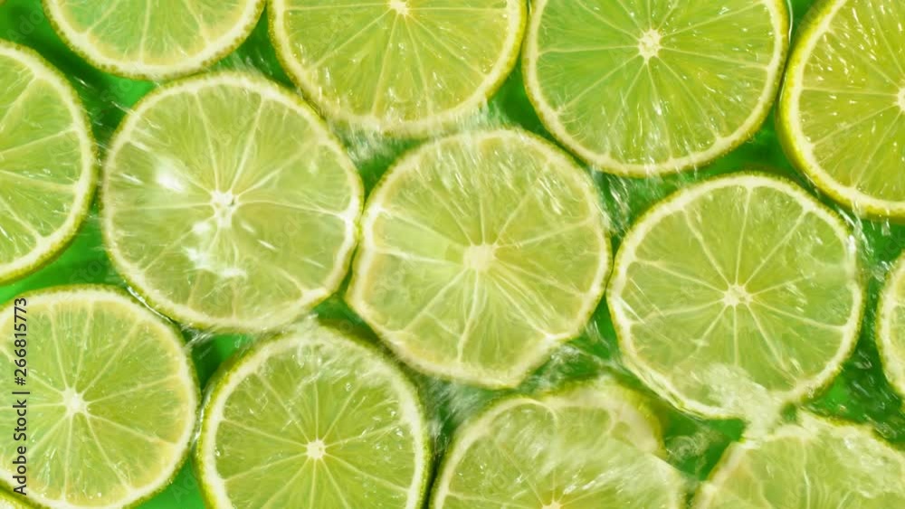 Super slow motion of falling lime slices into splashing water. Filmed on high speed cinema camera, 1000 fps. Super slow motion of falling lime slices into splashing water. Filmed on high speed cinema camera, 1000 fps.