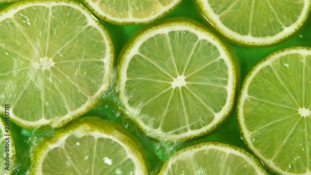 Super slow motion of falling lime slices into splashing water. Filmed on high speed cinema camera, 1000 fps. Super slow motion of falling lime slices into splashing water. Filmed on high speed cinema camera, 1000 fps.
