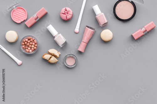 decorative cosmetics for make-up with macaroon cookies on gray tabletop background space for text © 9dreamstudio