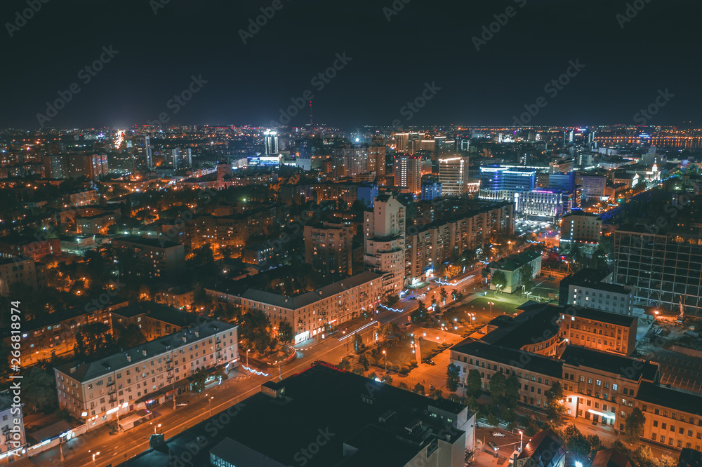 Aerial panoramic view from drone above night city Voronezh downtown and historical center with illuminated roads and modern high-rise buildings