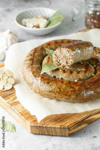 baked homemade sausage with spices and herbs, close up. Spiral grilled  sausage.