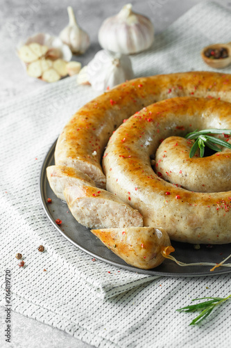 baked homemade sausage with spices and herbs. Spiral grilled homemade sausage.