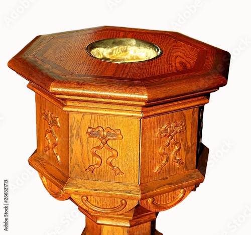 Fotografija Close-up of antique wood eight sided baptismal font isolated on white with sun s