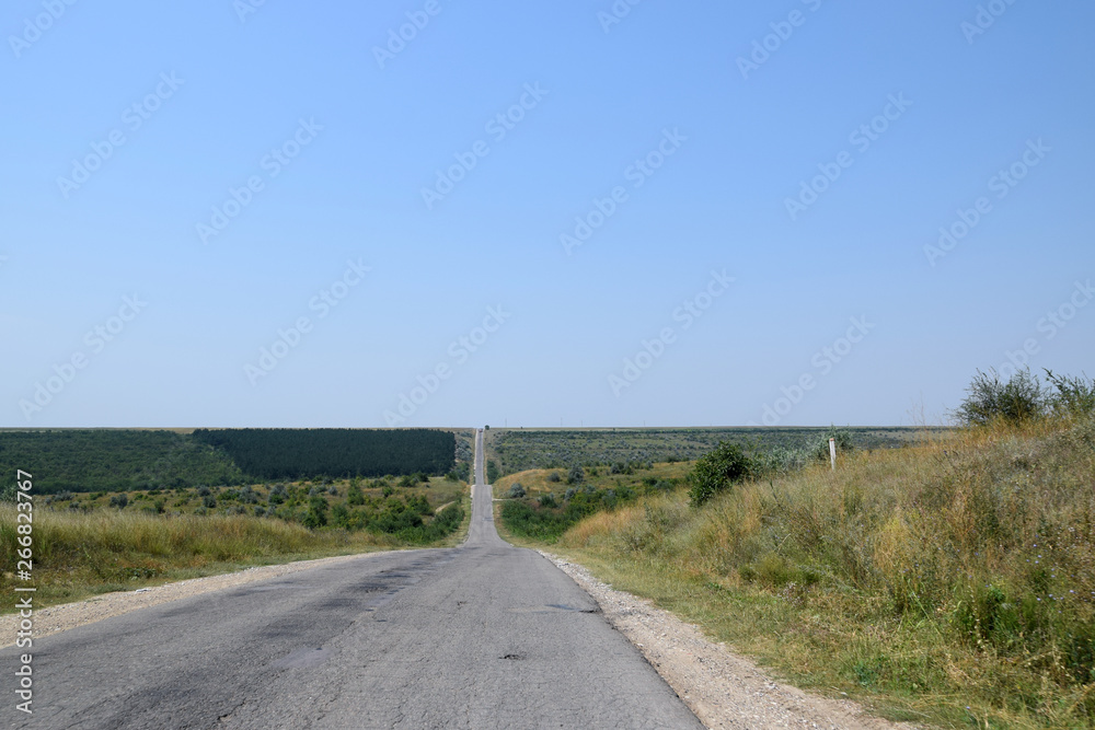 Road through hills and valleys. Rural road in Republic of Moldova.