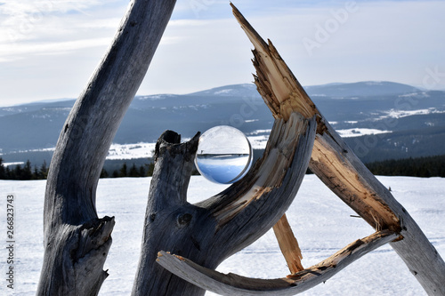 Winter mountains landscape in crystal ball.