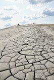Dry, cracked earth near Mud Volcanoes (Vulcanii Noroiosi) in Berca. Buzau, Romania.