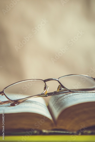 Back to school concept. Glasses on a book. Open book with glasses.