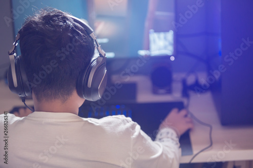 Portrait of asian boy gamer playing games on computer in the room at home