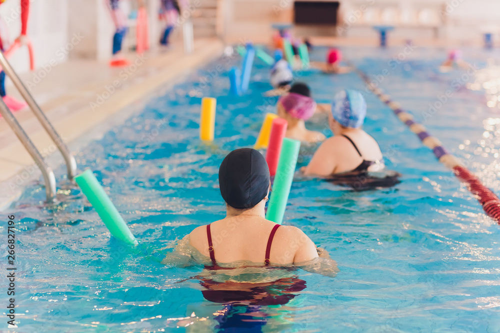 women trains in aqua aerobics, learn to swim. - obrazy, fototapety, plakaty 