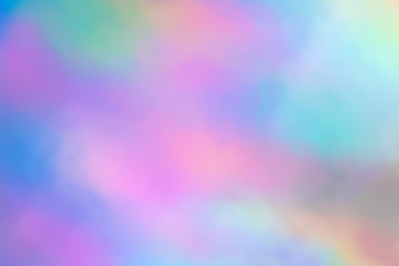 Blurry abstract iridescent holographic foil background.