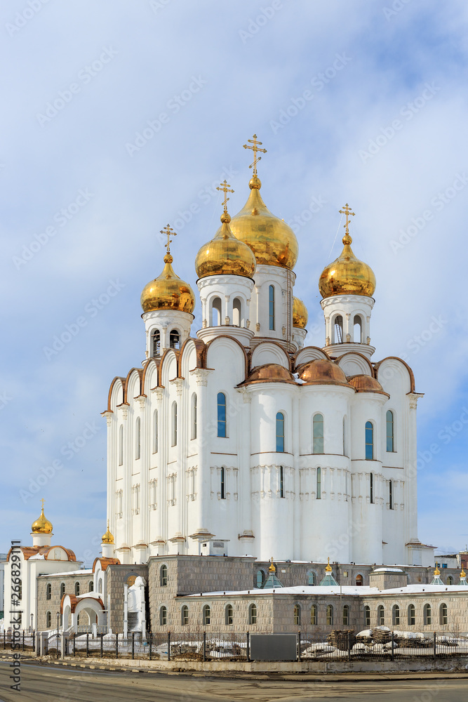 Holy Trinity Cathedral. Christian orthodox church. Beautiful large white building with golden domes and crosses. Russian Orthodox Church. Magadan, Siberia, Far East of Russia.